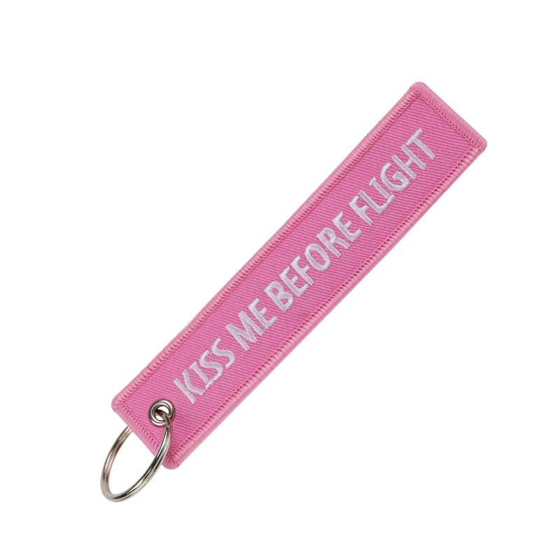 Pink woven flight ribbon keychain for a kiss me before flight theme