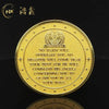 A gold medal coin featuring an emblem and text on its surface.