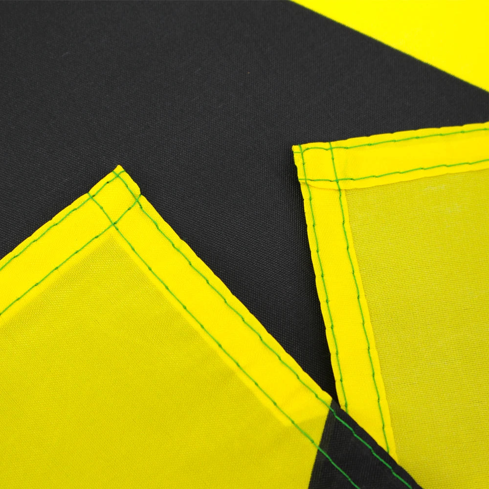 Yellow fabric with green stitching and black trim, showing a section of the Jamaica National Flag tapestry.