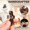 A hand holds a dark wooden comfort prayer cross, handcrafted with love and faith, finished with food-safe tung oil.