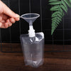 A hand is squeezing a clear reusable liquid drink pouch, demonstrating its squeezable feature.