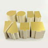 A set of metallic gold and silver dessert cake boards stacked together.