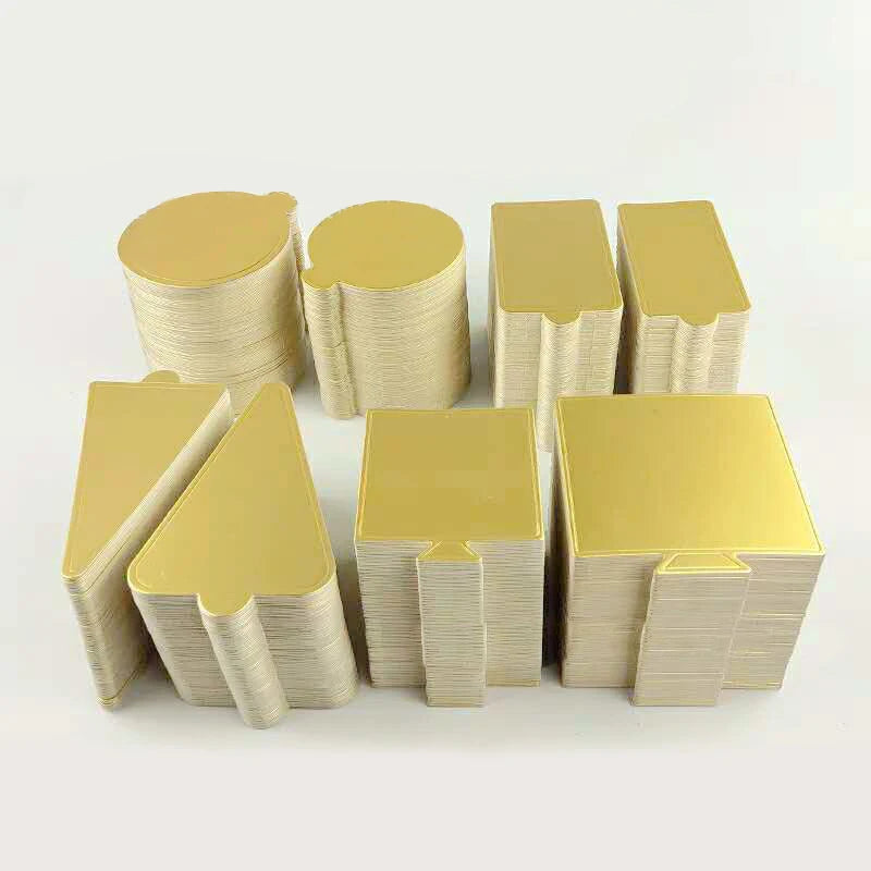 A set of metallic gold and silver dessert cake boards stacked together.