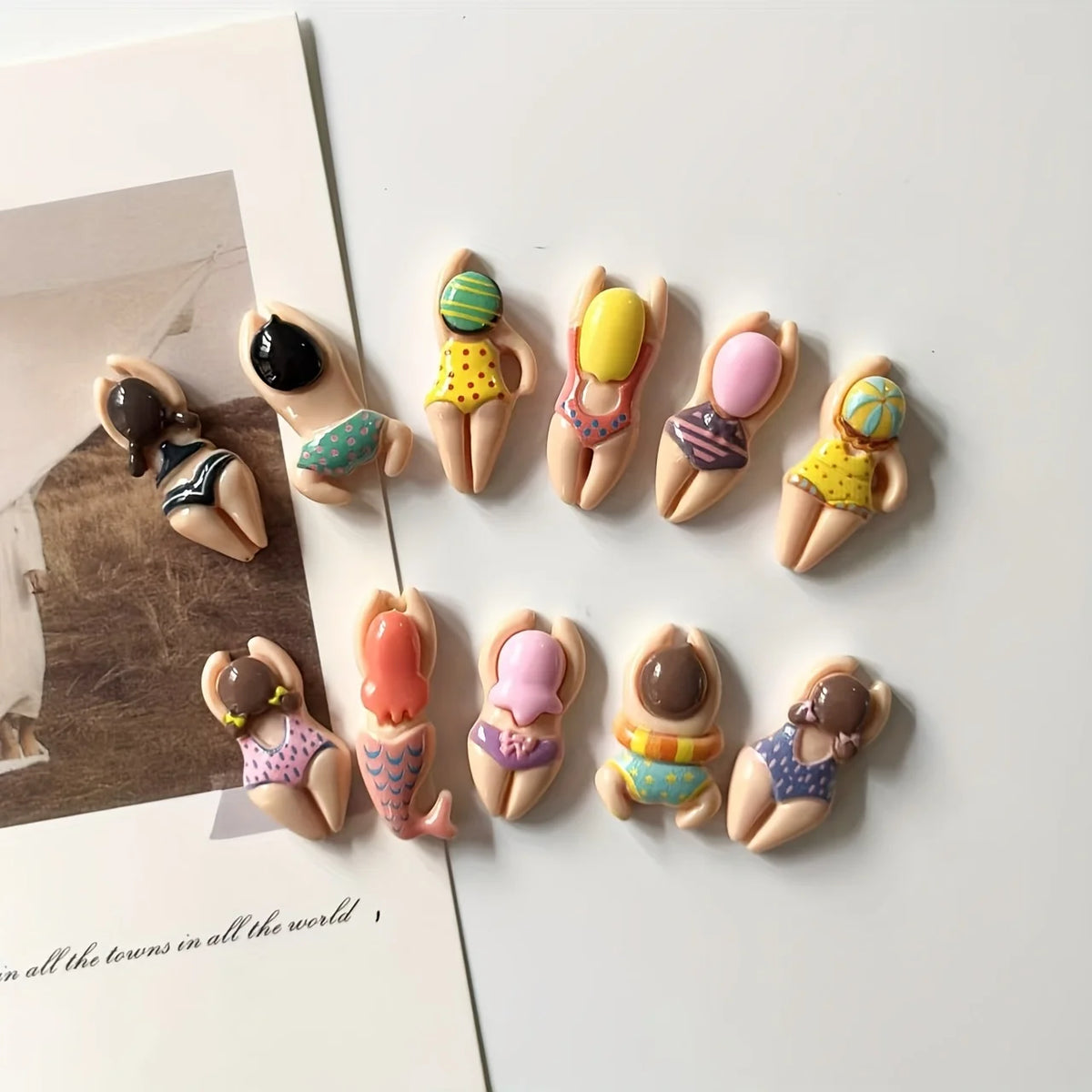 A collection of six resin fridge magnets featuring various colors and designs.