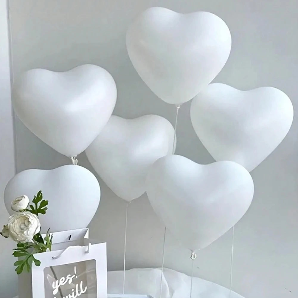 A cluster of white heart-shaped latex balloons is displayed against a white background.
