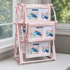 A pink rotating photo frame display featuring twelve slots, each showing a person lying down.