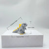 A gray 3D printed collectible figure of Godzilla sitting on a white display base.