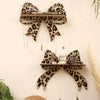 Leopard print wall mounted storage rack displaying small decorative items.