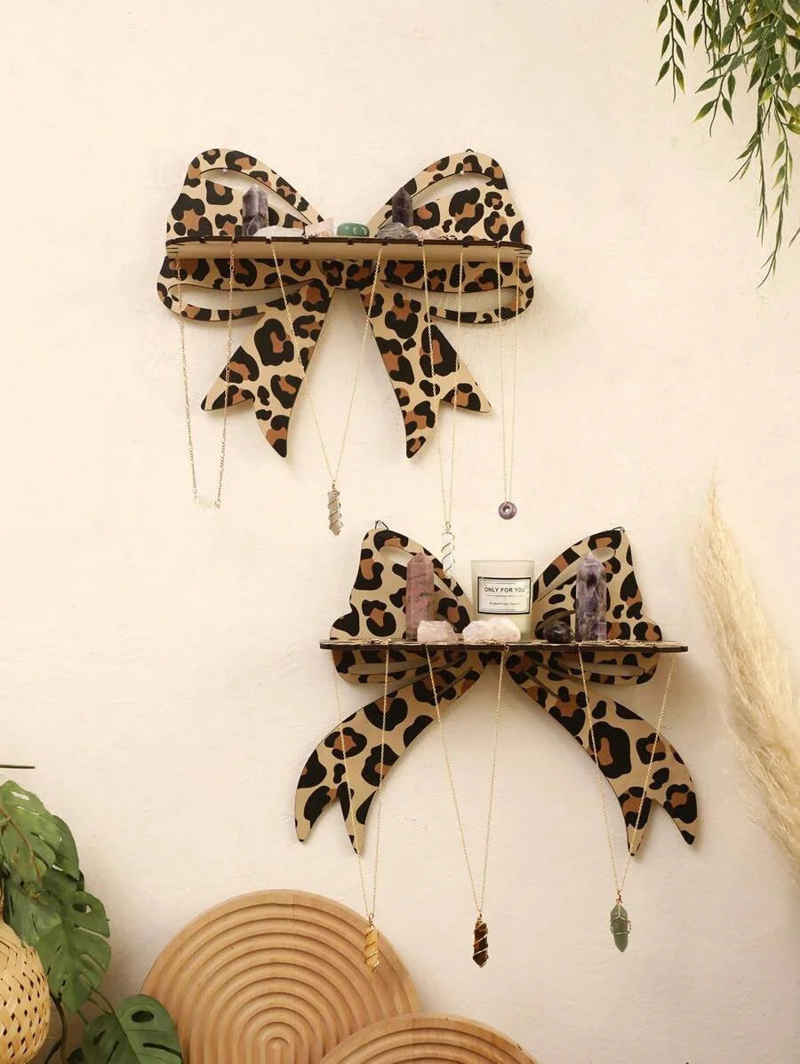 Leopard print wall mounted storage rack displaying small decorative items.