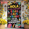 A colorful classroom door banner featuring the text HOLA and illustrations of school supplies like beakers, books, and a glob