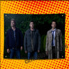 Three men in jackets posing against a dark green background on a yellow polka-dot patterned banner.