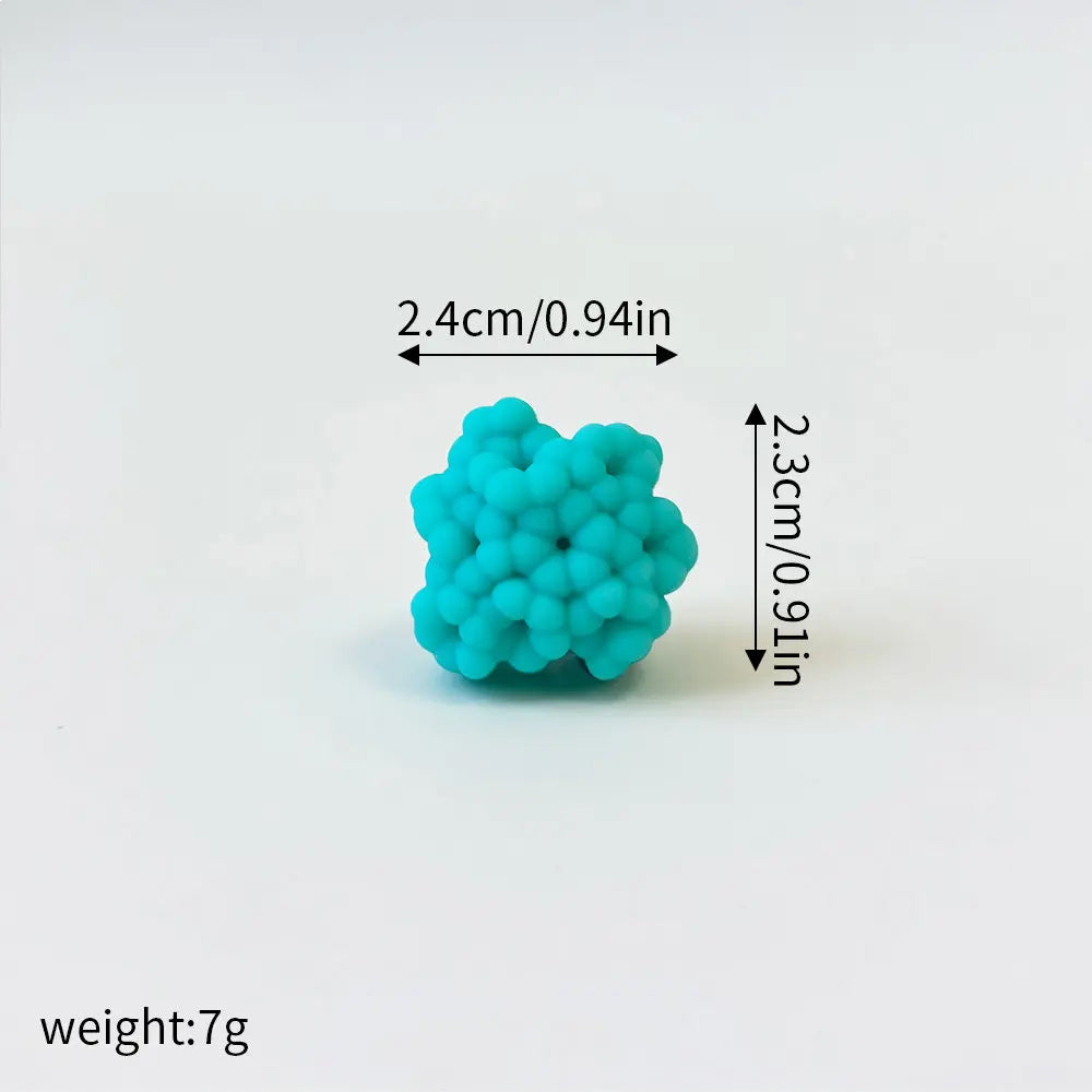 A set of three small, bright turquoise foam cake toppers shaped like a whale, octopus, and turtle.