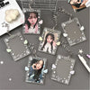 A collection of clear acrylic photo card holders with star charms and chains displayed on a gray surface.