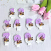 A collection of purple and gold numbered character birthday candles on a white surface.