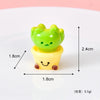 A small, bright green cat charm with a yellow pot base and a smiling face, used for crafts or dollhouse décor.