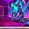 A dark room features a glowing UV reactive tapestry depicting a wizard and jellyfish, illuminated by neon light.