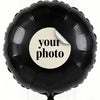 A black foil balloon with a white circle sticker that says your photo