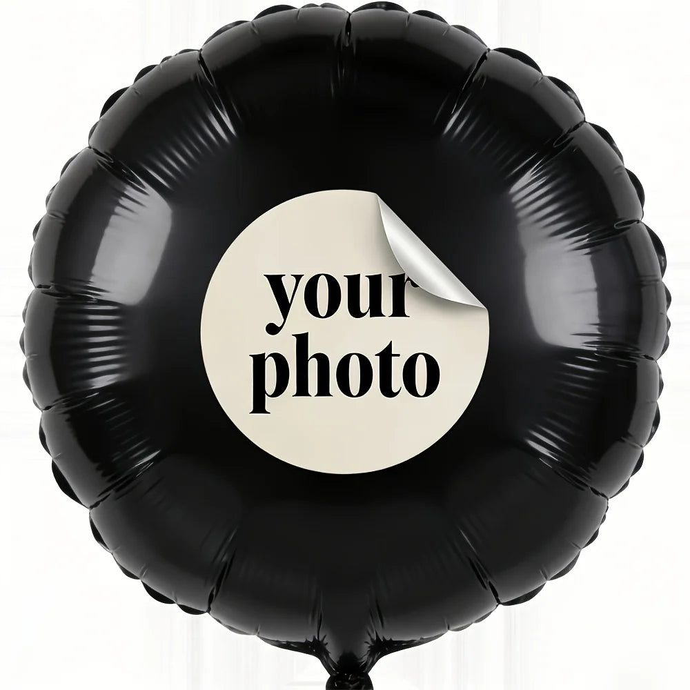 A black foil balloon with a white circle sticker that says your photo