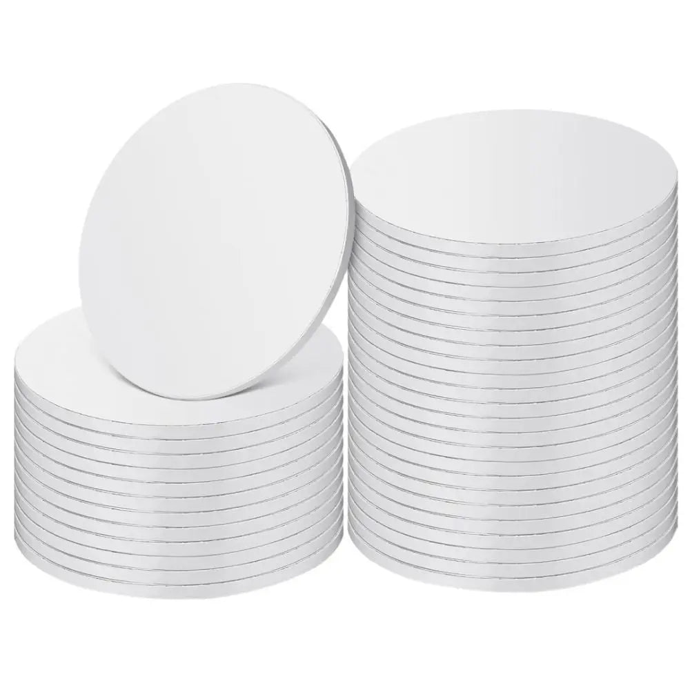 A stack of round white corrugated cake boards for disposable cakes.