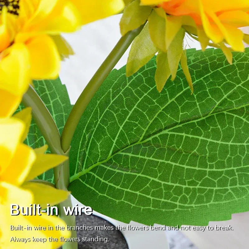 A close-up of a yellow sunflower flower and green leaf with built-in wire structure.