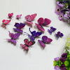 A collection of twelve colorful 3D butterfly wall decor stickers in shades of pink, purple, and magenta scattered on a white 