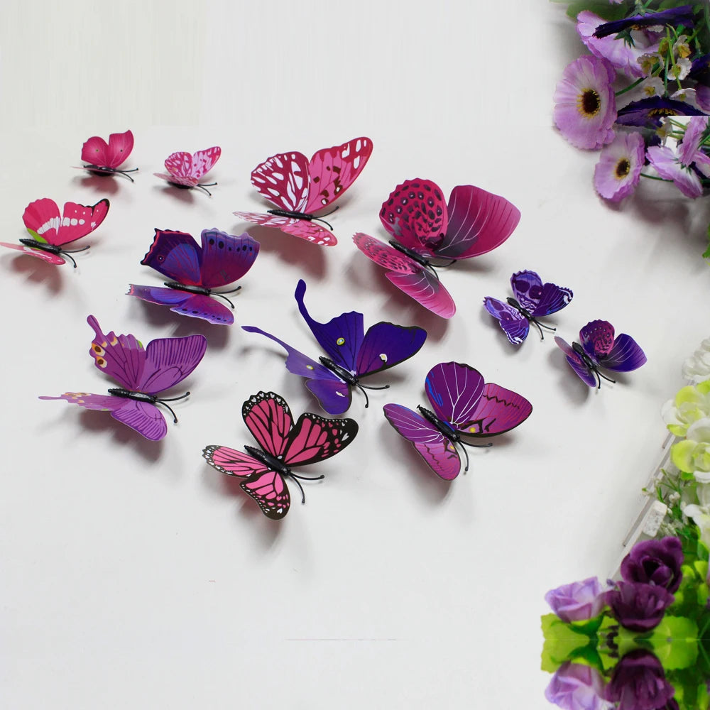 A collection of twelve colorful 3D butterfly wall decor stickers in shades of pink, purple, and magenta scattered on a white 