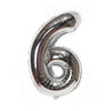 A metallic silver foil balloon shaped like the number six.