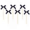 A set of pink bow cupcake toppers for birthday and bridal shower decorations.