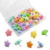 A variety of decorative pentagram thumb tacks in various colors including pink, yellow, green, and purple are displayed in an
