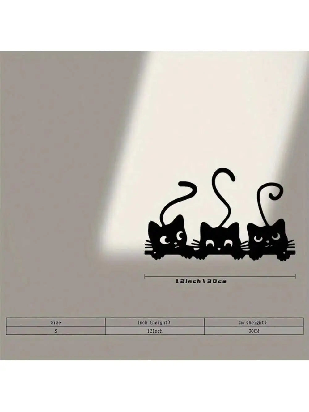 Black metal wall decor featuring three stylized cats with curled tails.