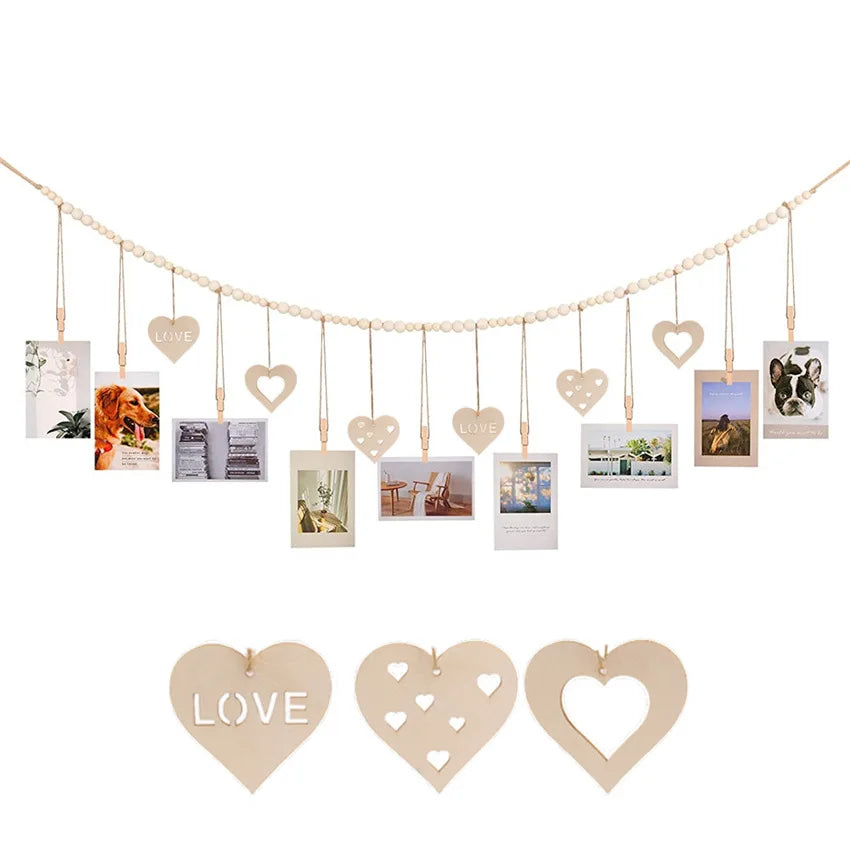 A string of heart-shaped wooden photo displays hangs across a line, featuring various photographs.