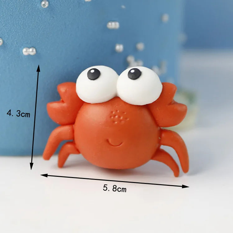 An orange crab figure with large white eyes and visible claws, shown against a blue background.