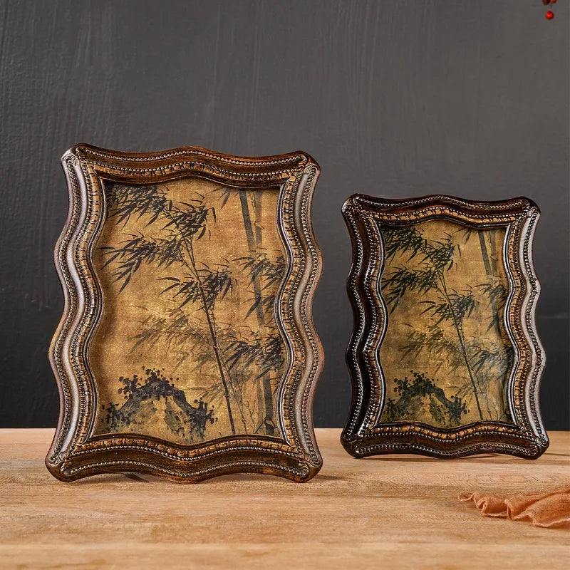 A vintage resin photo frame decor with a distressed gold and olive green background featuring bamboo silhouettes.
