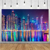 A photograph of a vibrant night city skyline with illuminated high-rise buildings reflected in calm water.