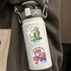 A white water bottle with a nature-themed sticker featuring wildlife and text.