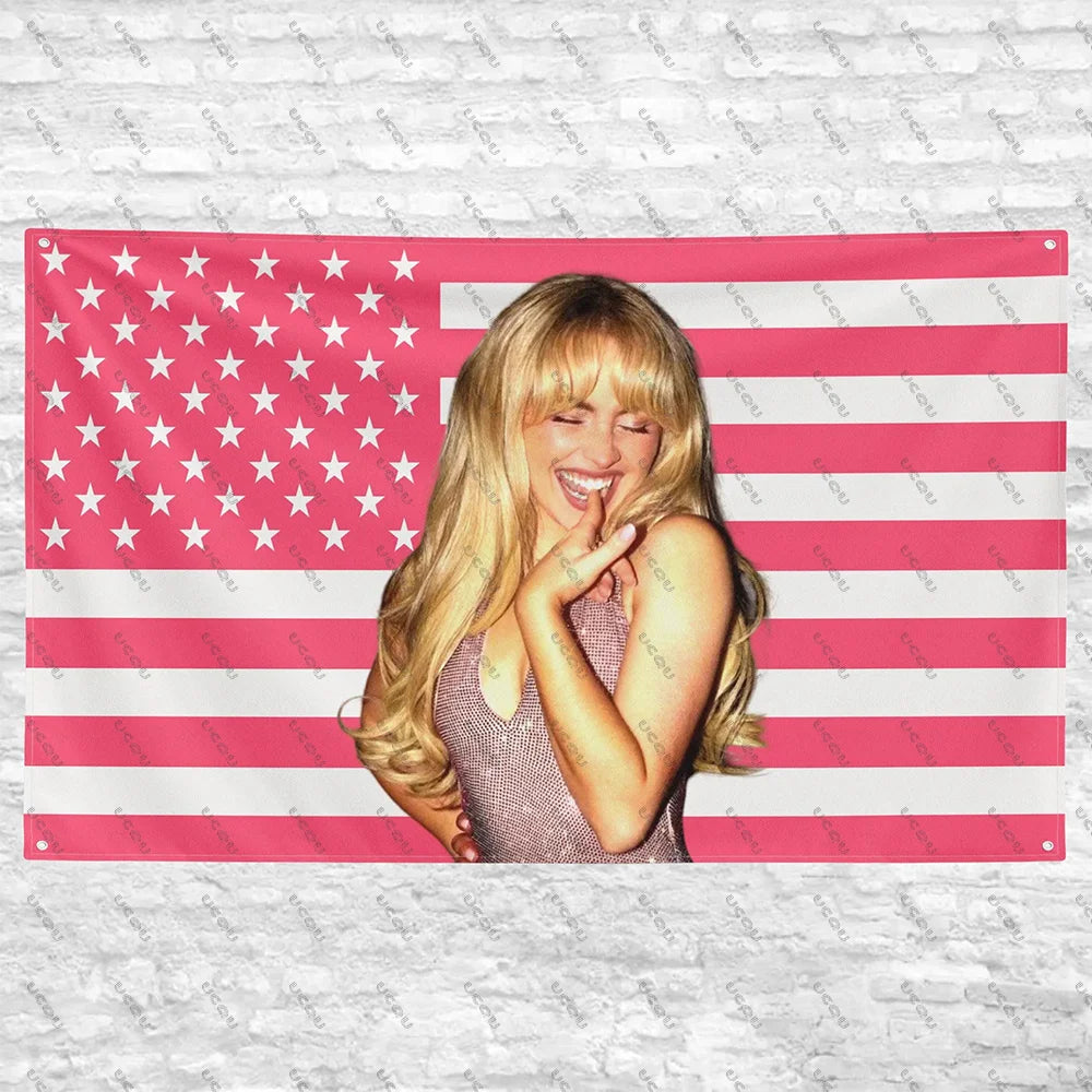 A pink and white American flag tapestry featuring a blonde woman smiling and touching her face.