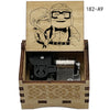 A wooden music box featuring a drawing of a man and woman, with internal mechanical components.