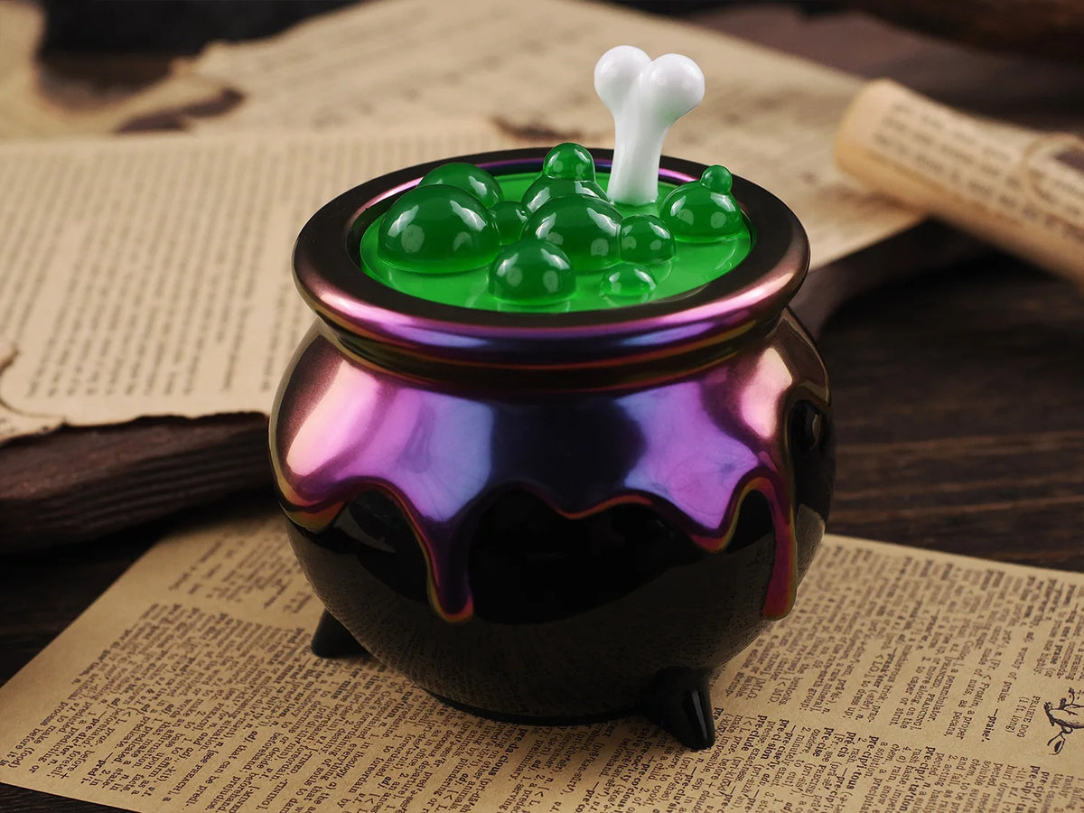 A dark purple glass jar filled with green silicone mold material topped by a white, tooth-shaped silicone piece.
