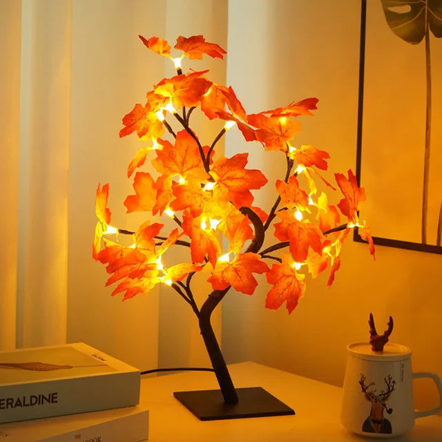 Leuchtender Baum in Form einer Orangenrose mit leuchtenden Blättern auf einem dunklen Ständer.