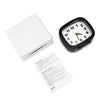 A black analog alarm clock with a luminous display and snooze function is shown on a white background.
