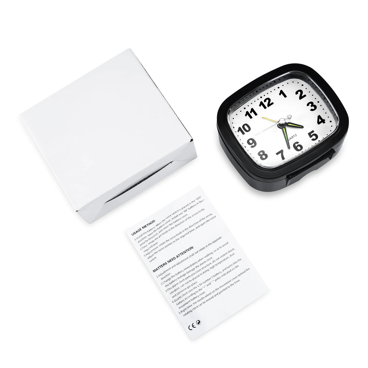 A black analog alarm clock with a luminous display and snooze function is shown on a white background.