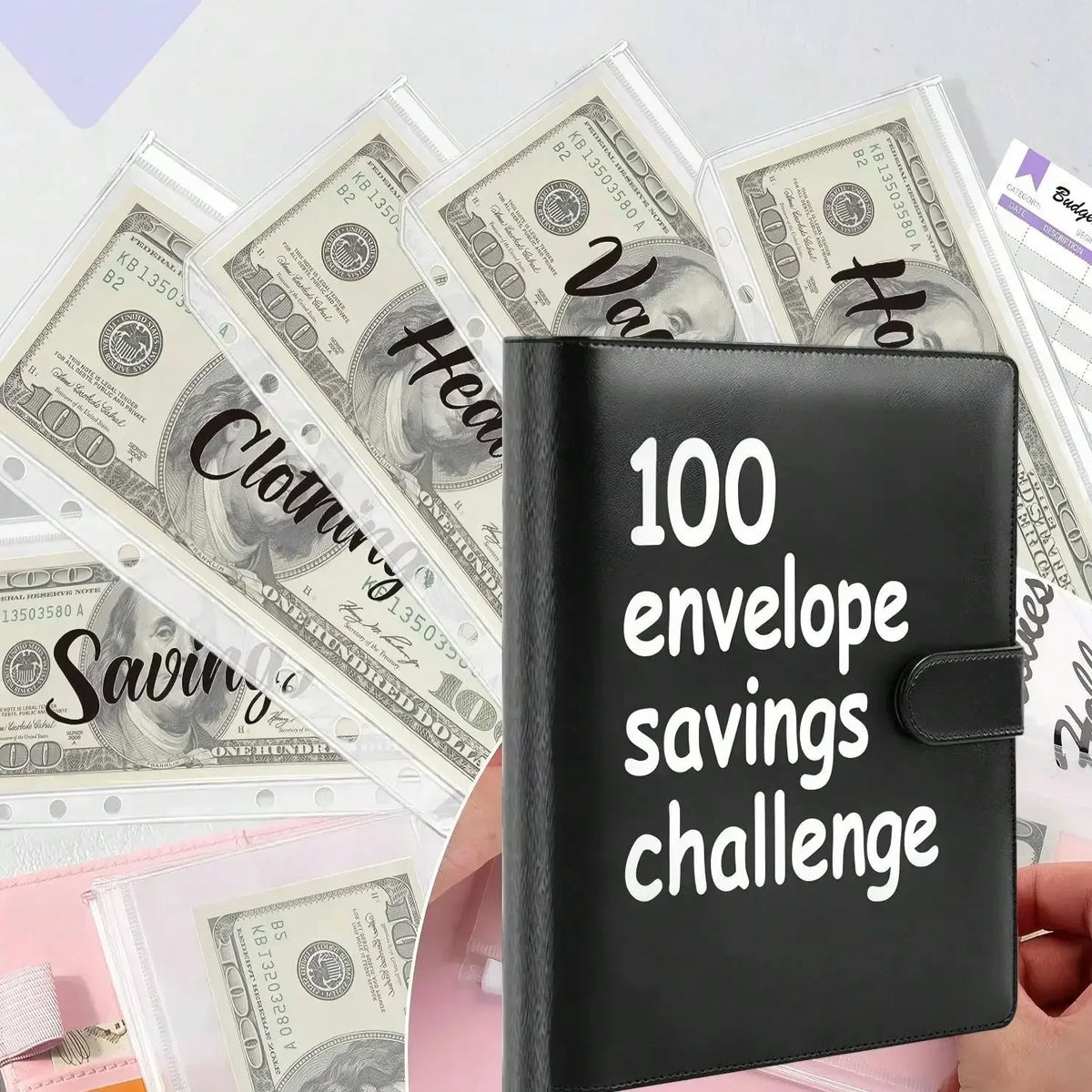 A black leather savings planner binder is shown next to stacks of US dollar bills.