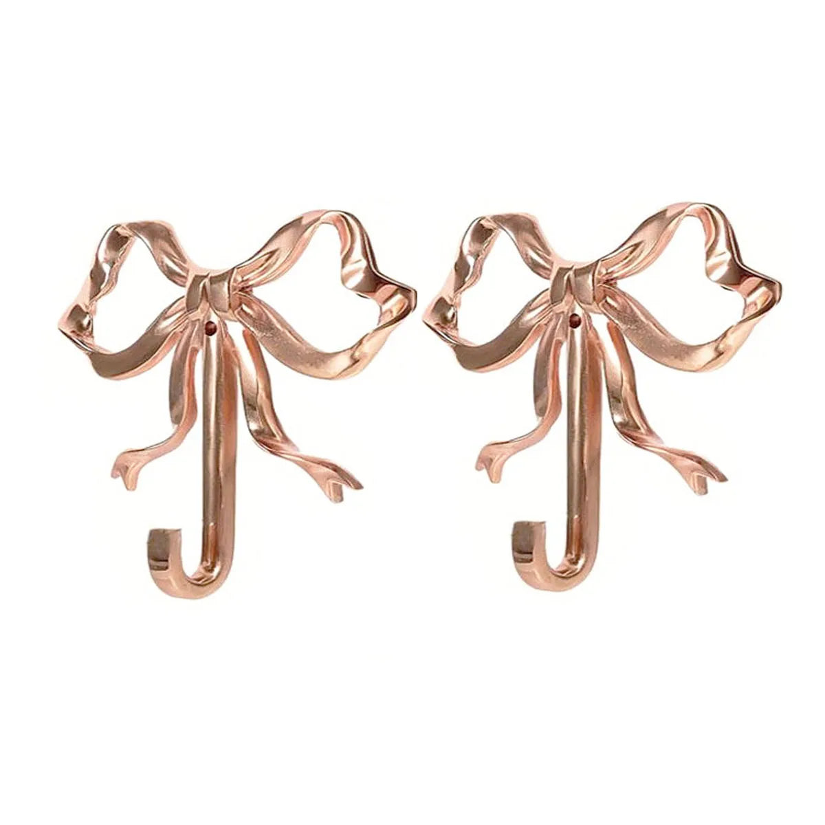 A pair of elegant brass bowknot wall hooks designed for home organization.