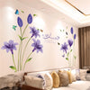 Purple and blue floral wall stickers featuring flowers and butterflies on a white wall.