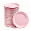 A stack of pink disposable paper plates is shown next to a single plate.