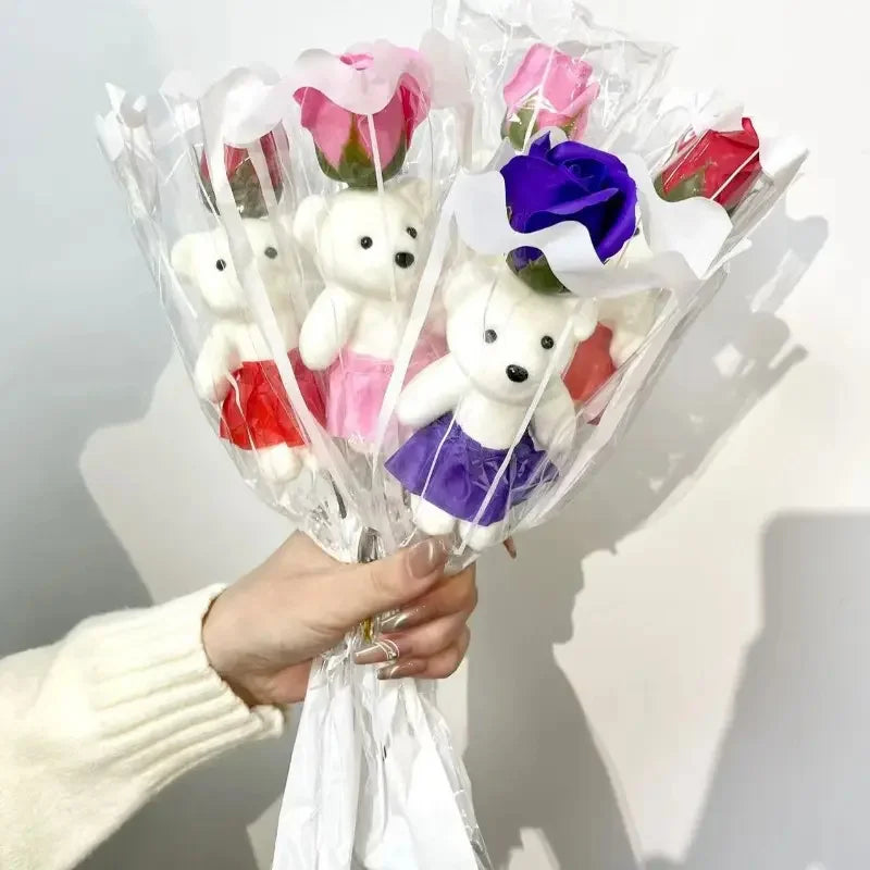 A bouquet of artificial rose soap featuring white teddy bears in pink and purple wrapping.
