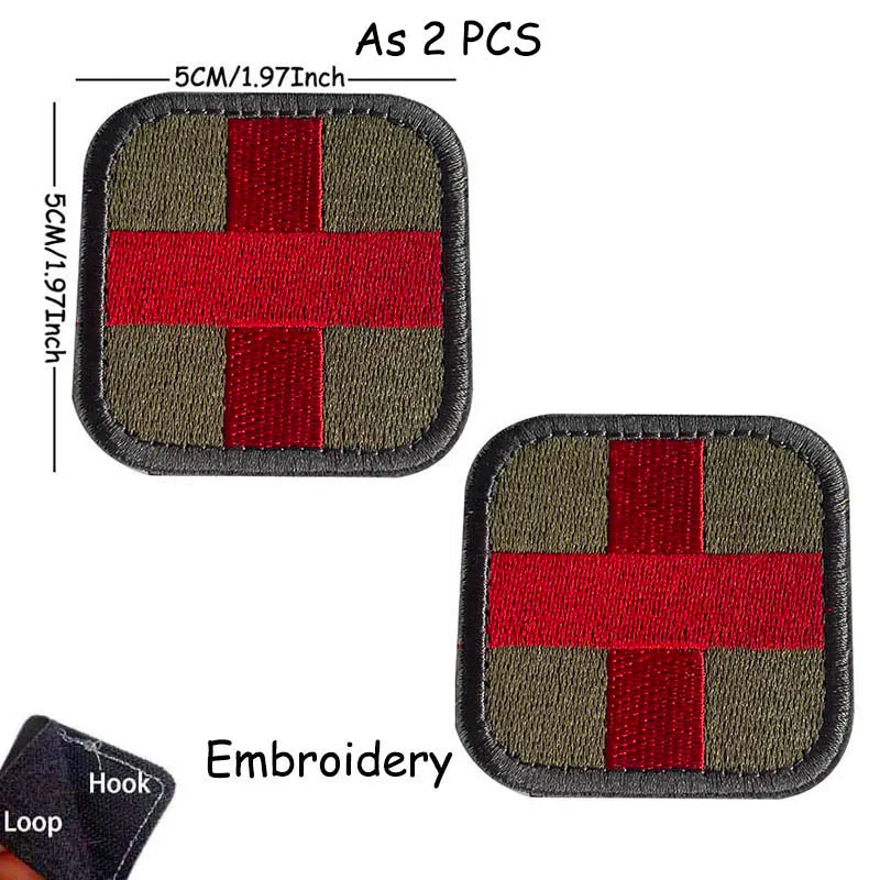Two embroidered medical cross tactical morale patches, one olive green and red, shown with a hook and loop.