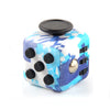 A blue and white marbled fidget cube with black and gold dots and a black lid.