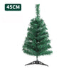 A small, green artificial Christmas tree with lights on a stand.