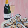 A glass of champagne next to oysters on ice on a pink plate.